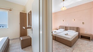 A bedroom with a bed, bedside tables, a wardrobe, a window, and a view of the sea. - Apartment 'Alex Bar 7' with Sea View, Wi-Fi and Air Conditioning (Parga)