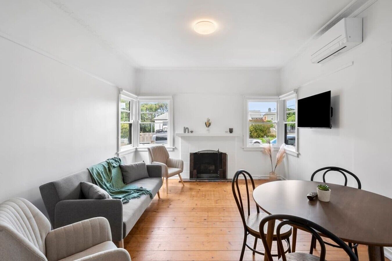 Bright and welcoming living area with comfortable seating, Smart TV and natural light.