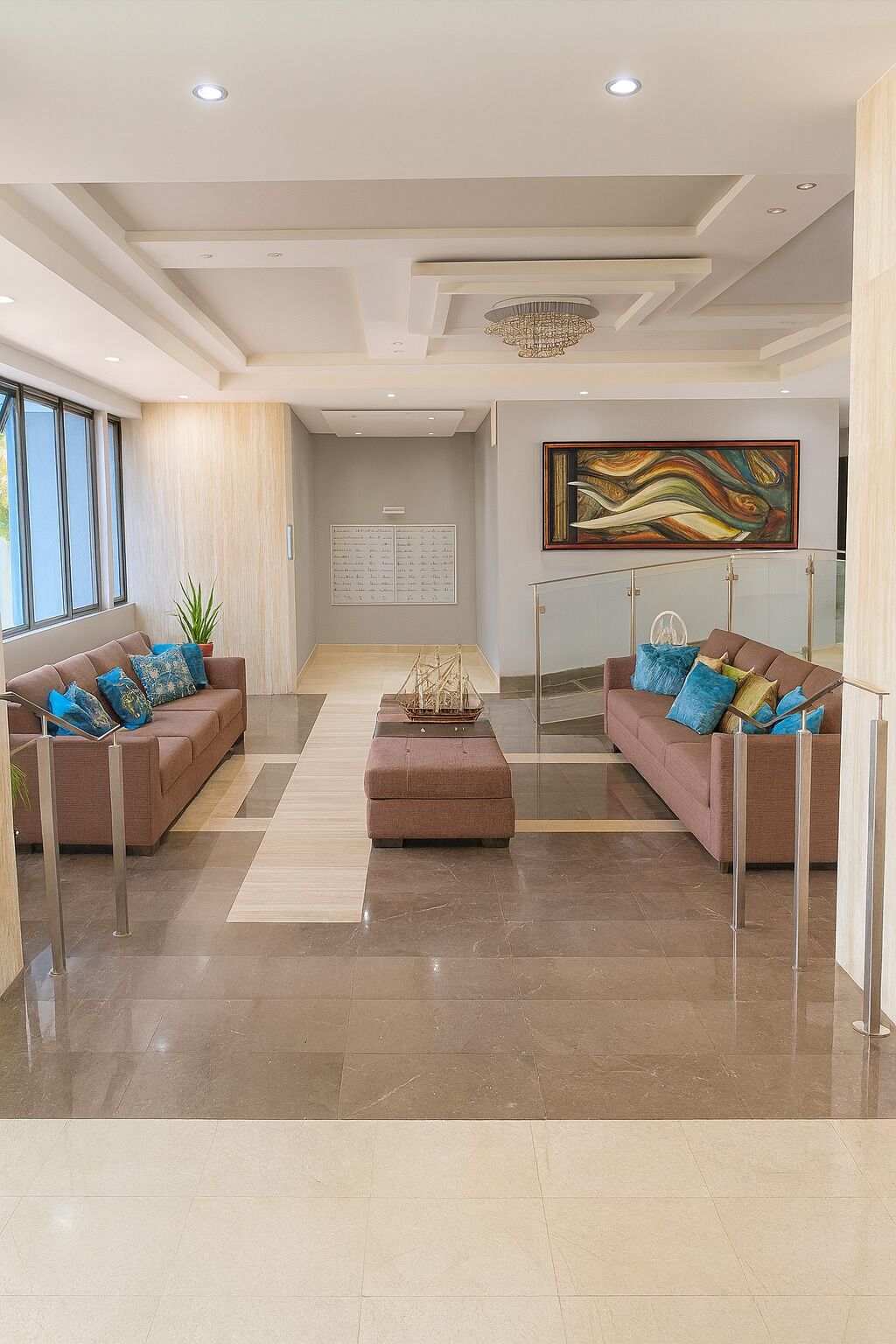 A spacious living room with two sofas, a coffee table, and a chandelier.