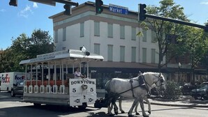 A trolley with horses at a street intersection. - Perfect Work Retreat on Market St. Downtown ILM (Wilmington)