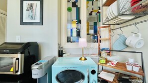 A compact kitchen with a retrofitted coffee machine, a microwave, and a small sink. - Perfect Work Retreat on Market St. Downtown ILM (Wilmington)