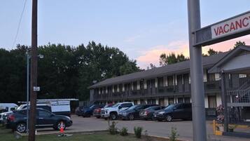 A Regency Inn sign, a parking lot with several cars, and a building with a 'VACANCY' sign.