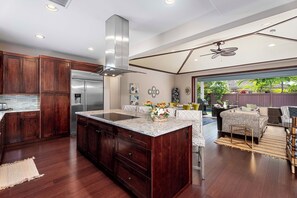 Enjoy cooking in this well-equipped kitchen with a large island, sink, and ample counter space.