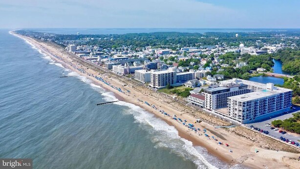 An aerial view of a coastal city with a long beachfront, several multi-story buildings, and a clear sky. - Modern & Clean, Family Friendly, 1st Floor Condo (Rehoboth Beach)