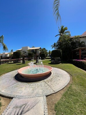 Stunning water feature surrounded by lush gardens and traditional architecture.