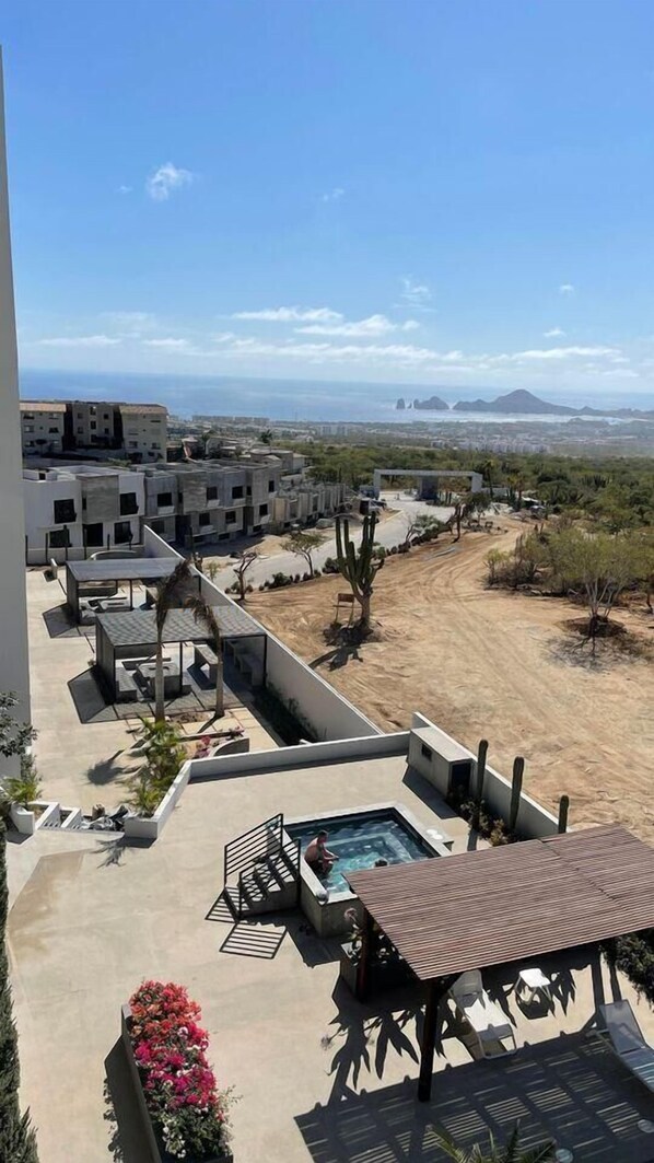 A rooftop pool area with a view of a desert landscape and distant mountains. - Sabina Residencial  (Cabo San Lucas)