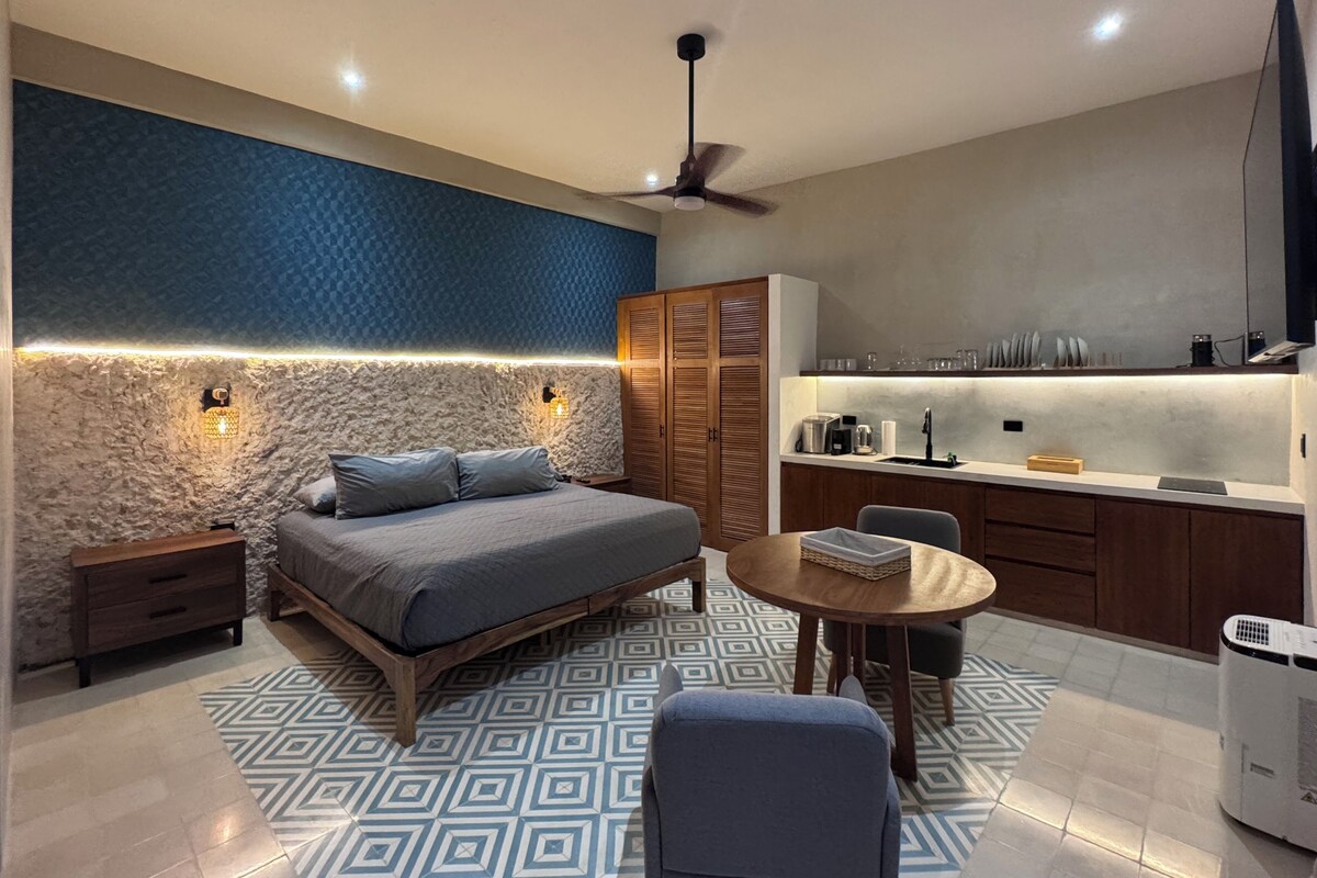 A modern bedroom with a bed, bedside tables, a ceiling fan, and a nightstand.
