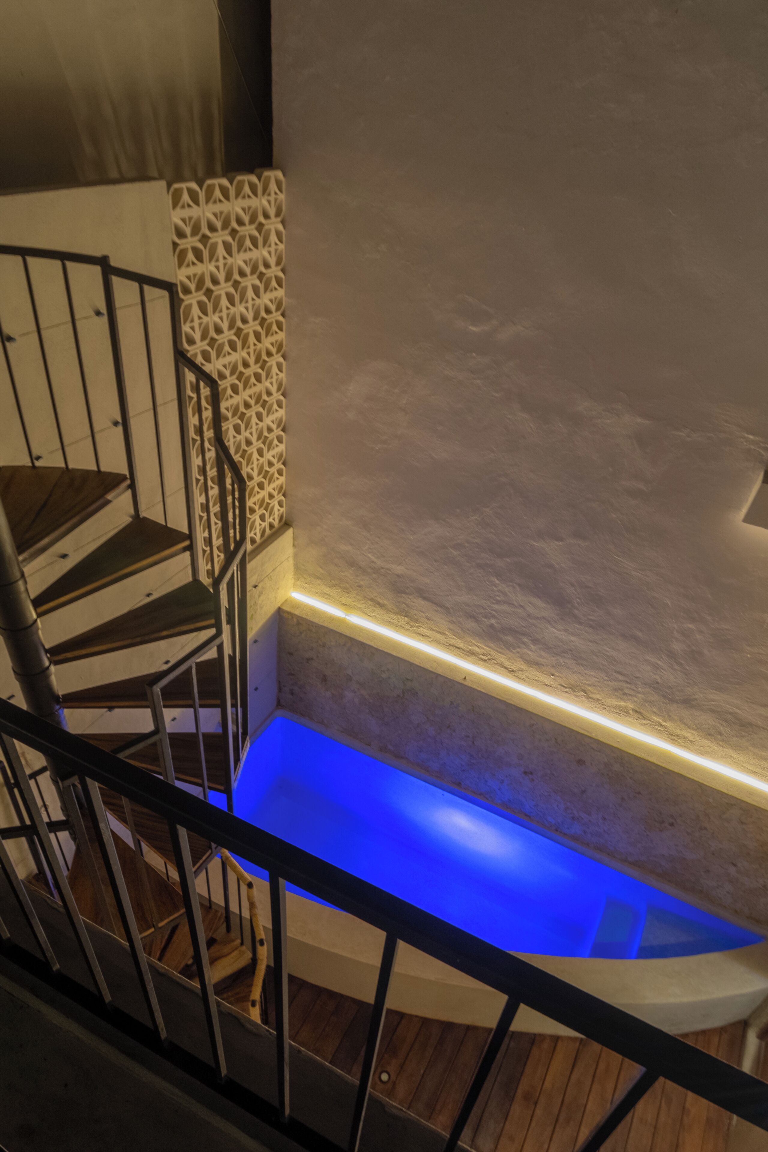 A staircase with a blue-lit ledge at the bottom.