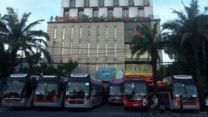 A multi-story building with a modern architectural design, featuring a grid-like facade with numerous windows. - Bac Kinh Hotel Vinh - by BAY LUXURY (Vinh Phu)