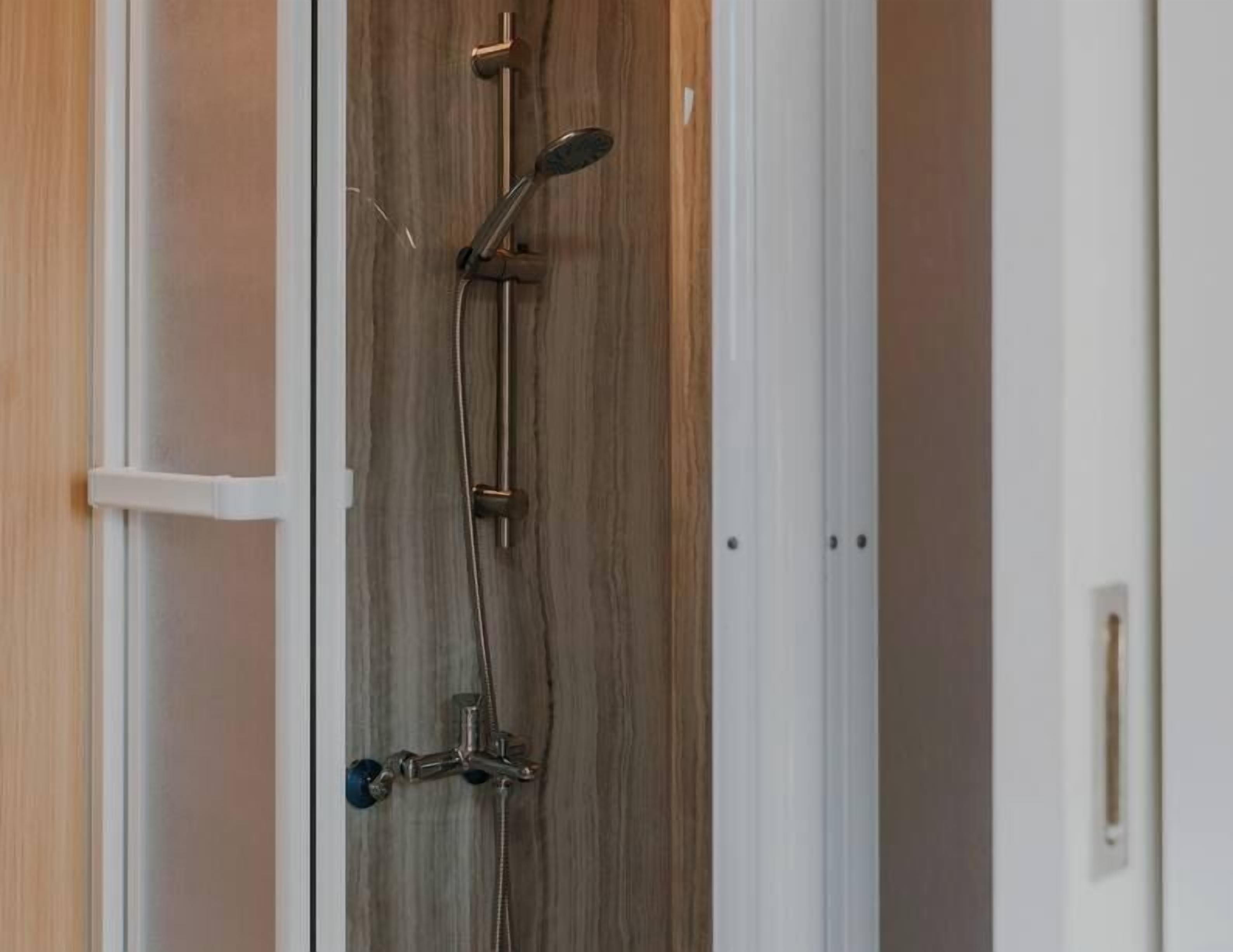Shower, hair dryer, towels, shampoo
