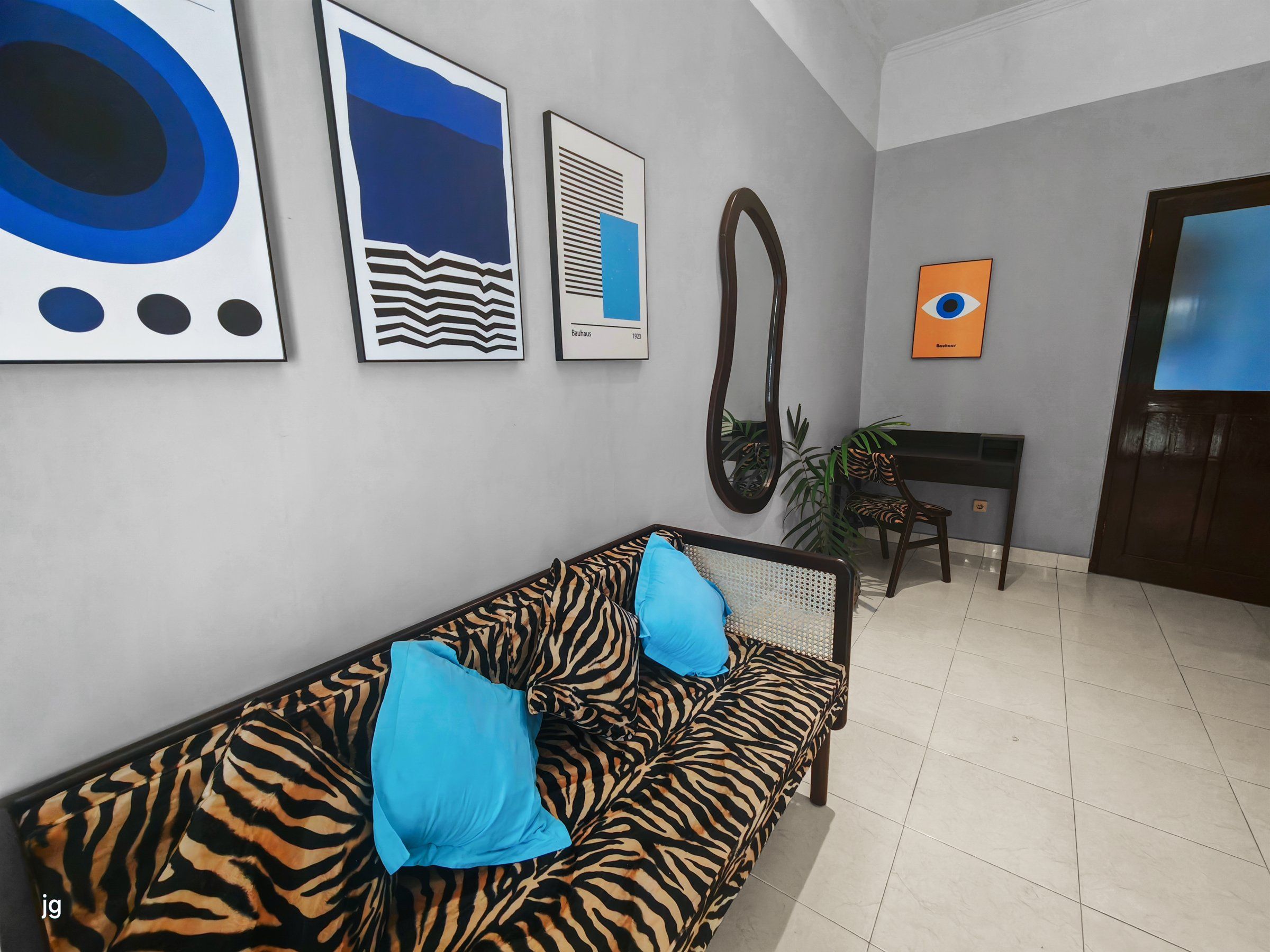 Sitting area with modern art and a zebra-print sofa