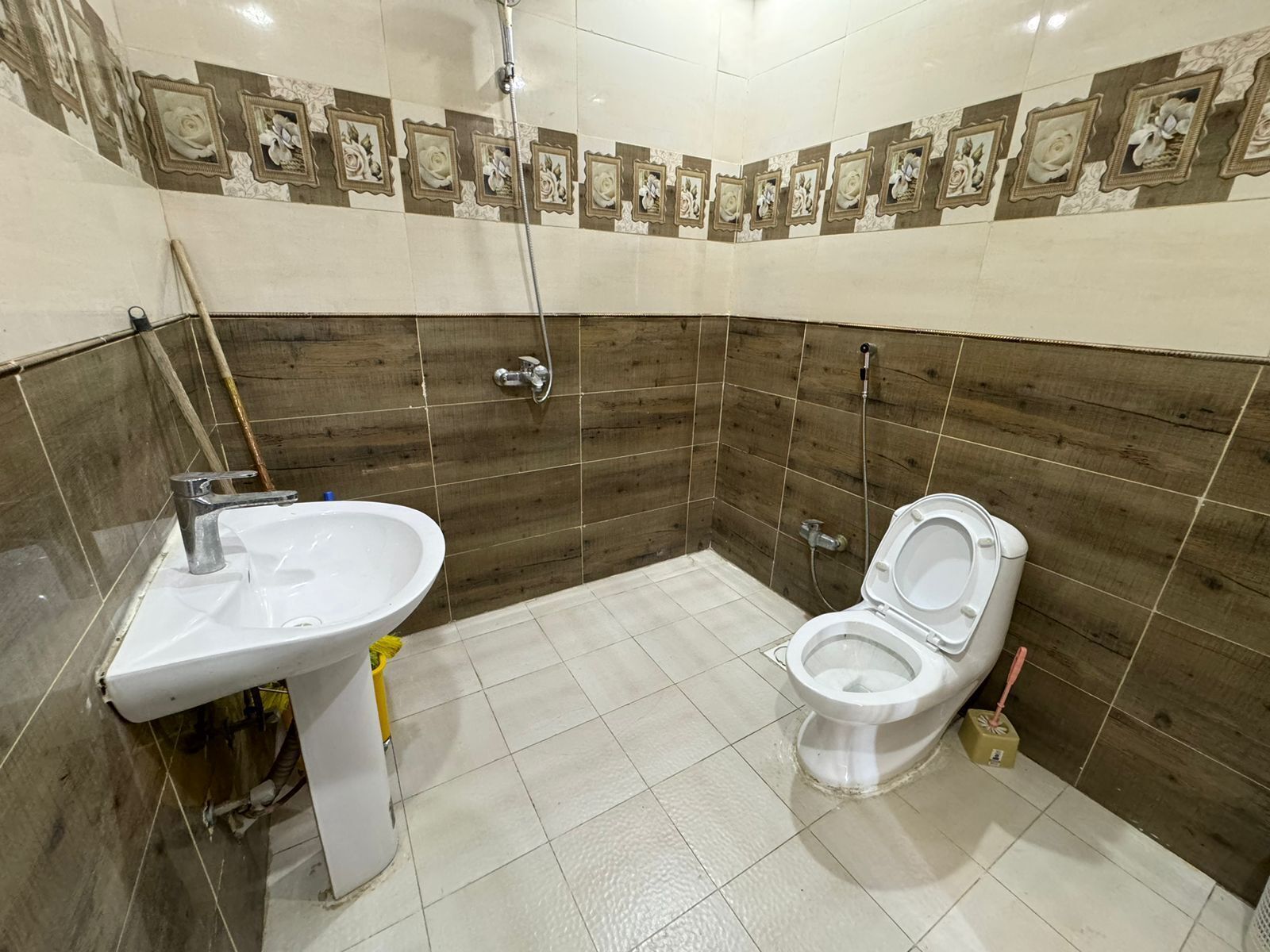 Un baño con lavamanos, inodoro y ducha.