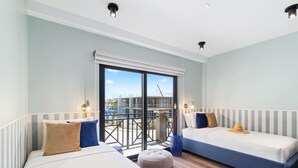 A modern hotel room with two beds, a balcony, and a view of the cityscape. - LUX 3BR House Pool Gym 7-Min Walk to Palm Beach - Porta al Sole 19 by Bocobay (Noord)
