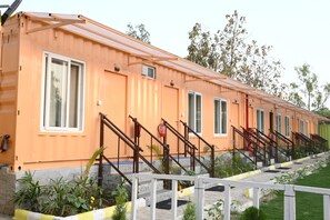 Stroll through a serene landscape of single-story buildings with entrances and charming views.