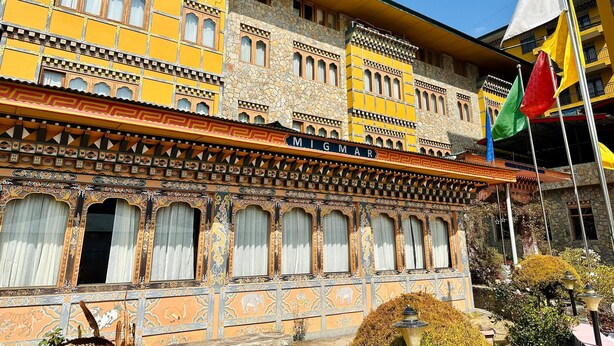 Ein Gebäude im traditionellen Baustil, mit aufwendigen Fenstergestaltungen und einer Beschriftung mit dem Schriftzug "MIGMAR".