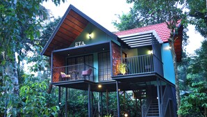 A two-story house with a balcony and a red roof, surrounded by greenery. - Bay View Suites Vythiri (Vythiri)