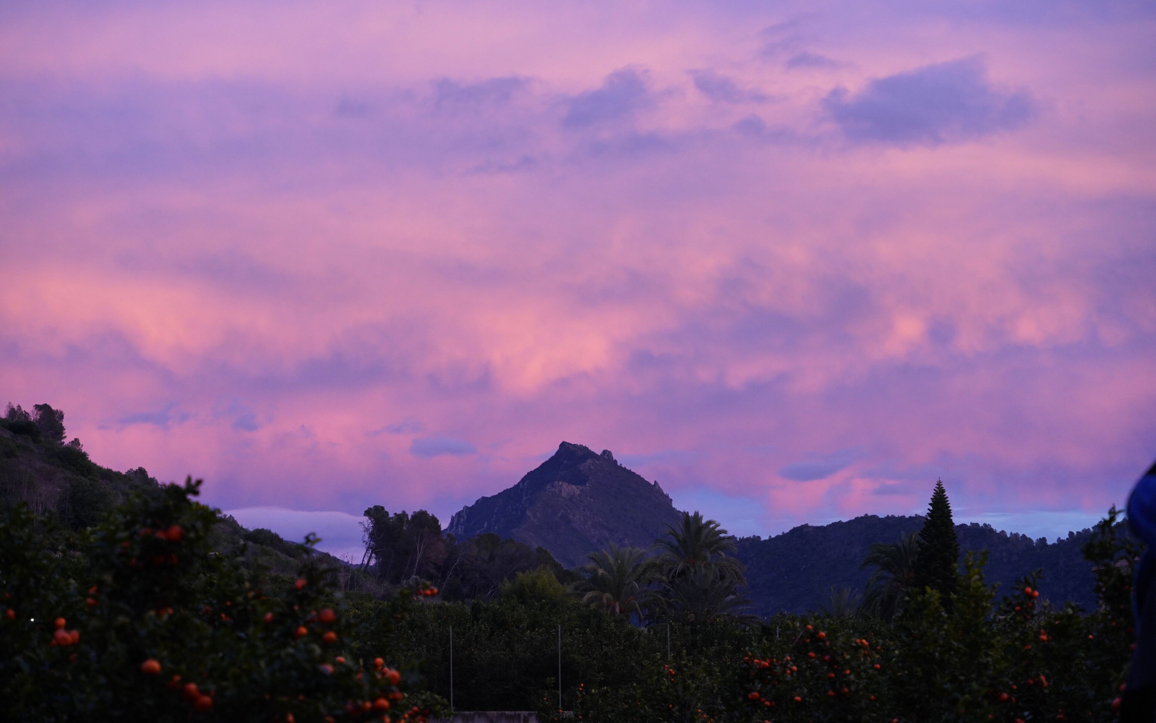A mountain landscape with a purple sky.