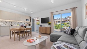 A modern apartment with a kitchen, dining area, and living room.