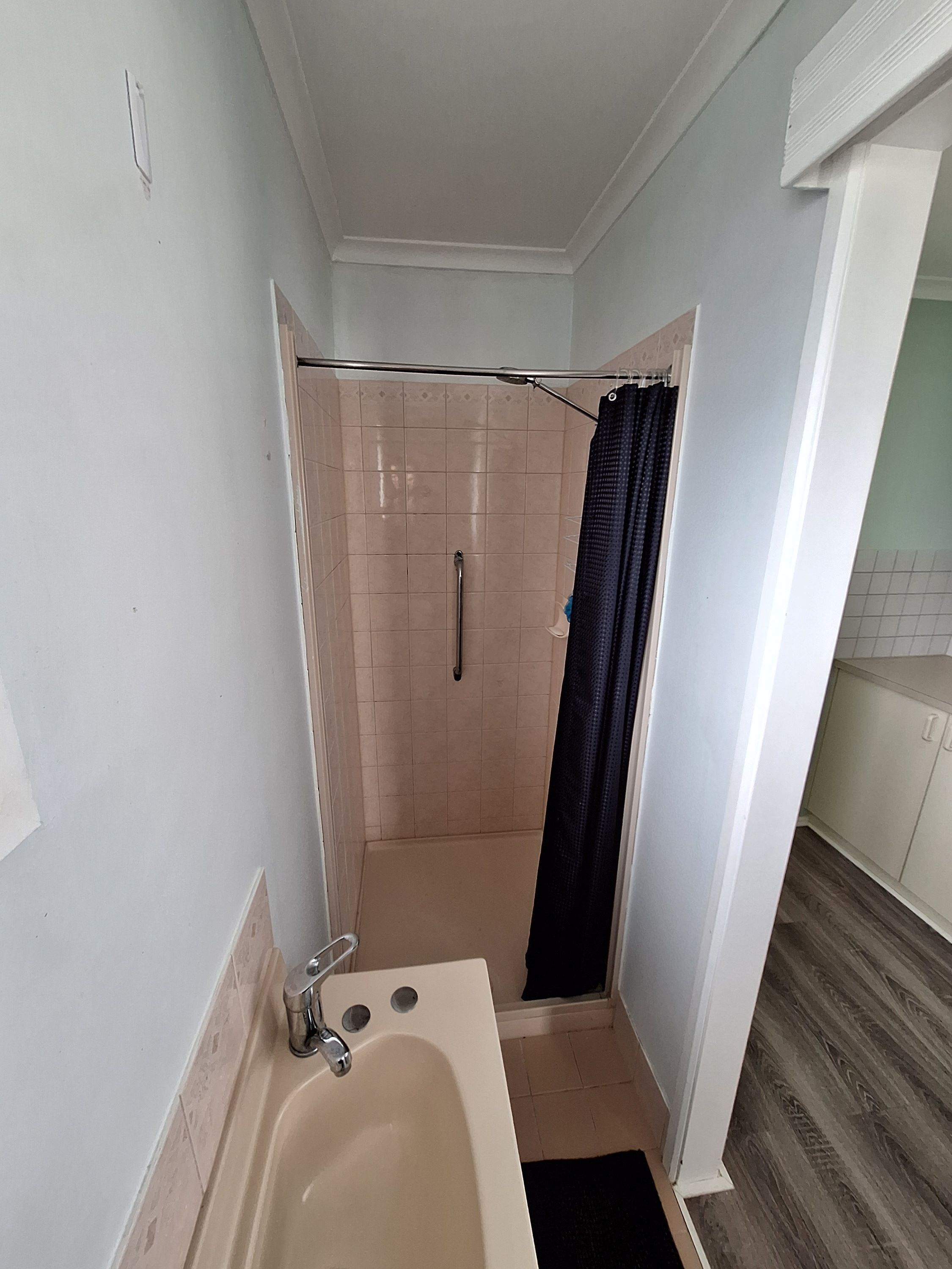 A small bathroom with a bathtub, a shower, and a toilet.