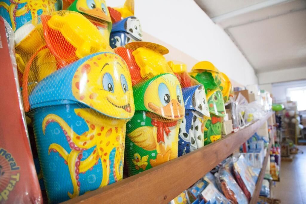 A variety of colorful, cartoon-themed containers on a shelf.