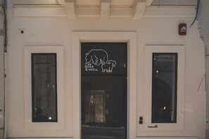 A building entrance with a sign reading "The Bear & The Ween" and a door number "107".