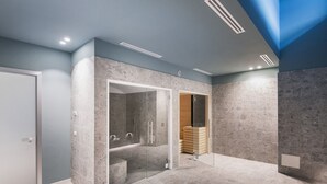 A modern bathroom with a glass-enclosed shower, a visible toilet, and a wooden storage unit. - Easylife - Apartment with Terrace and Comfort (Milano)