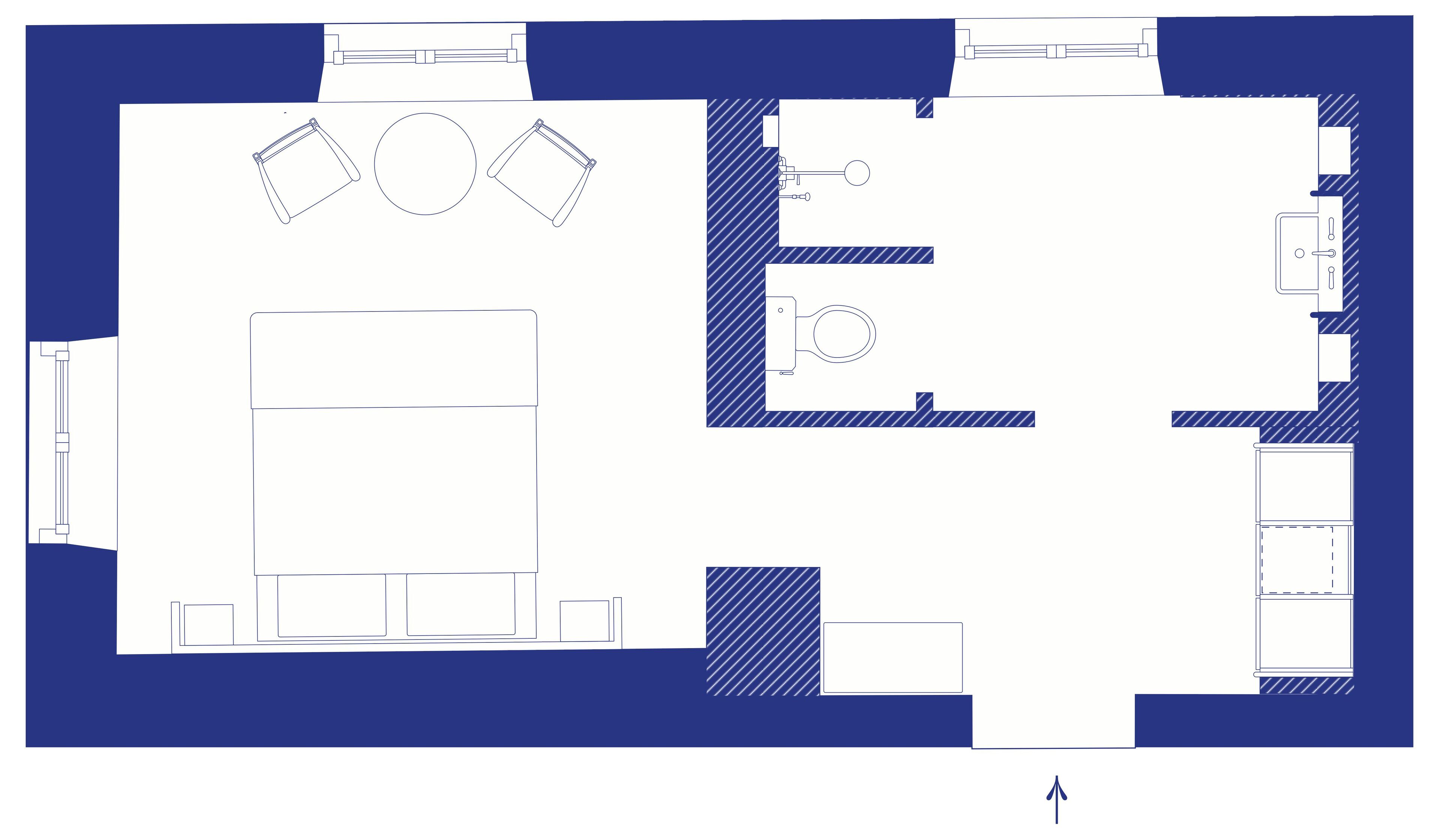 A floor plan of a hotel with a central seating area, a small kitchen, and a restroom.