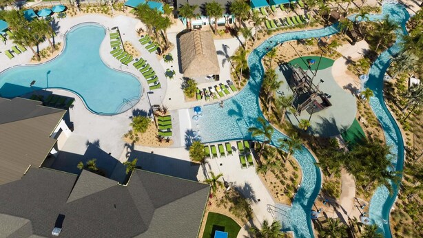 An aerial view of a resort with multiple swimming pools, sun loungers, and palm trees. - Storey Lake Resort, Private Pool, Near Famous Attractions!! (Kissimmee)