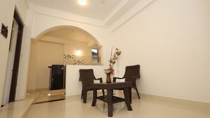 A spacious room with a dining table and chairs, a small refrigerator, and a decorative vase. - House of Brothers  (Arambol)
