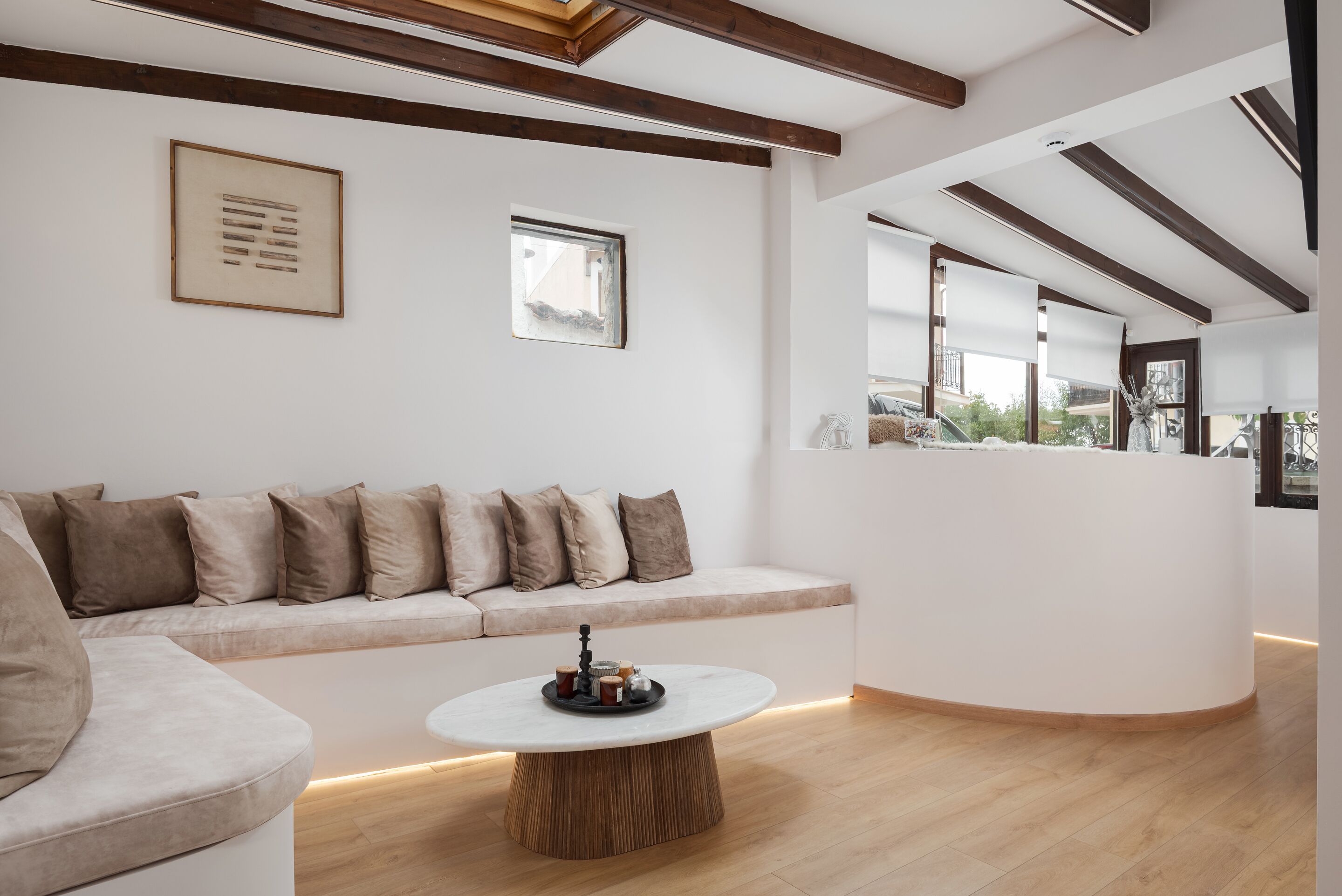 A modern interior with a sofa, a round coffee table, and a reception desk.