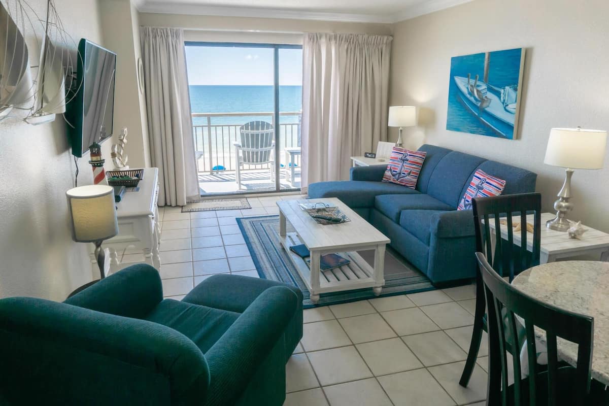 Deluxe Condo, 2 Bedrooms, Balcony, Beach View | Living room | 50-inch Smart TV with digital channels