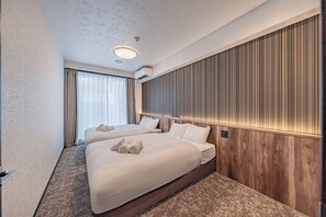 A hotel room with two beds, a large window with curtains, a wall-mounted air conditioner, and a ceiling light. - Apartment Hotel 11 Namba Motomachi (Osaka)