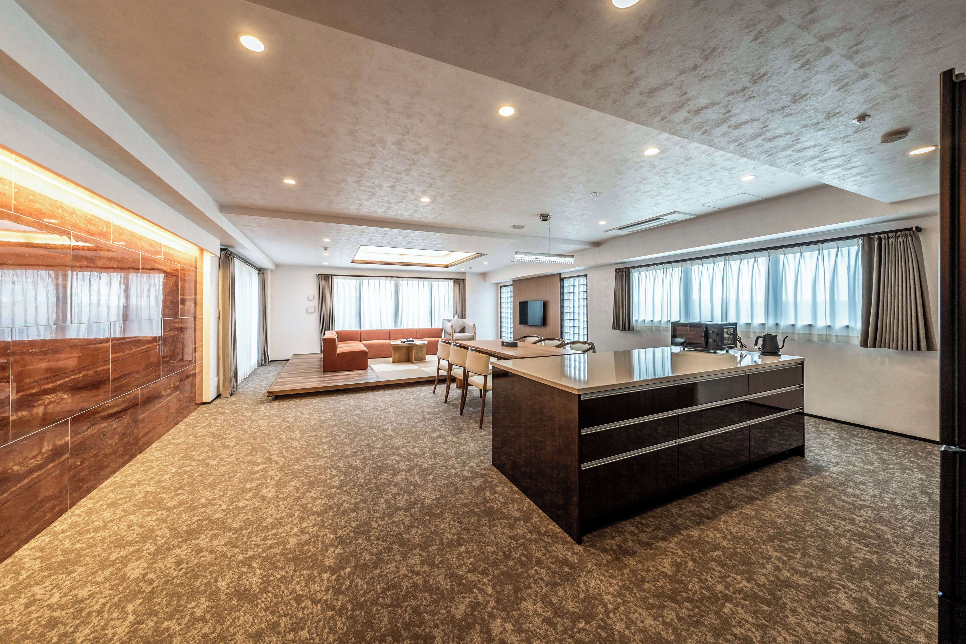 A spacious living area with a large island, a sofa, and a coffee table.