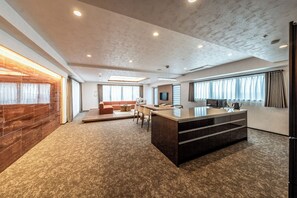 A spacious living area with a large island, a sofa, and a coffee table. - Apartment Hotel 11 Namba Motomachi (Osaka)