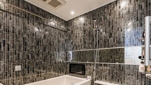 A modern bathroom with a freestanding bathtub, a glass shower enclosure, and a mirrored vanity. - Apartment Hotel 11 Namba Motomachi (Osaka)