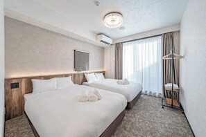 A hotel room with two beds, a chandelier, an air conditioning unit, and a window with curtains. - Apartment Hotel 11 Namba Motomachi (Osaka)