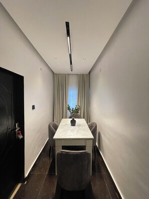 Enjoy meals at the dining table, flanked by two comfortable chairs.