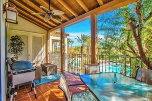 A covered outdoor area with a pool, seating, and a grill. - Overlook Oasis A | 1BR Legacy Villa (La Quinta)