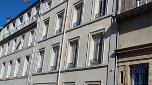 A multi-story building with uniform window designs and balconies.