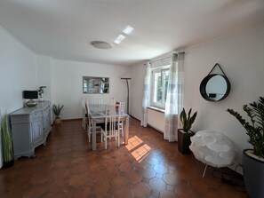 Enjoy a modern space with a dining area, comfortable seating, and a radiator for warmth.