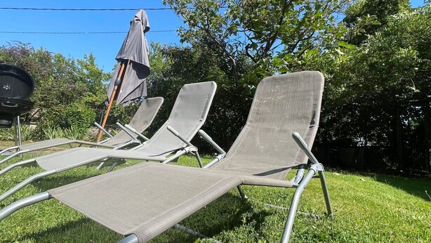 A grassy outdoor area with three reclining chairs and a barbecue grill. - Charming farmhouse with private garden and pond, perfect for exploring Berry (Gournay)