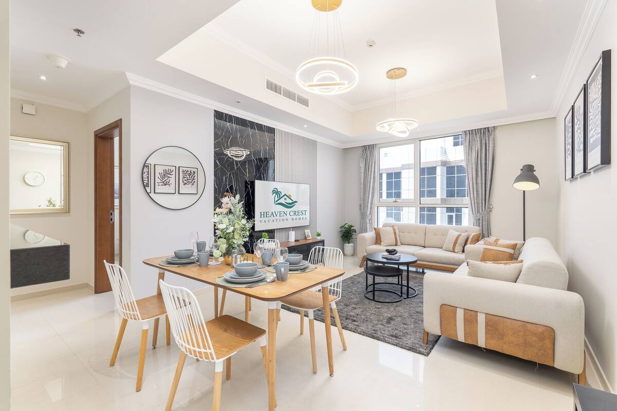 Un salon moderne avec un coin repas, comprenant un ensemble de canapés, une table basse et une table à manger avec des chaises.