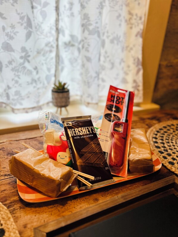 A tray with various chocolate bars, a Hershey's milk chocolate bar, a Hershey's chocolate bar, and a chocolate bar in a red wrapper.