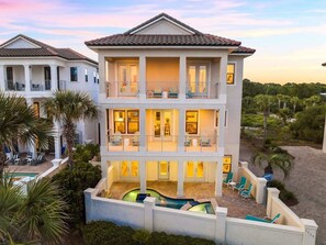 A multi-story hotel with a pool, balconies, and outdoor seating. - Sweet Melissa: Sleeps 14, Private Pool, Gulf Views (Santa Rosa Beach)