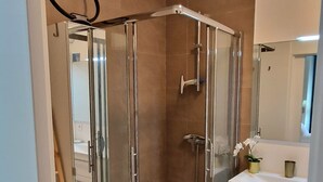 A modern bathroom with a glass-enclosed shower, a white vanity with a mirror, and a wooden ladder leading to a lower level. - "BlueSky" air-conditioning-wi-fi garage- 5m from town center.  (Aix-en-Provence)