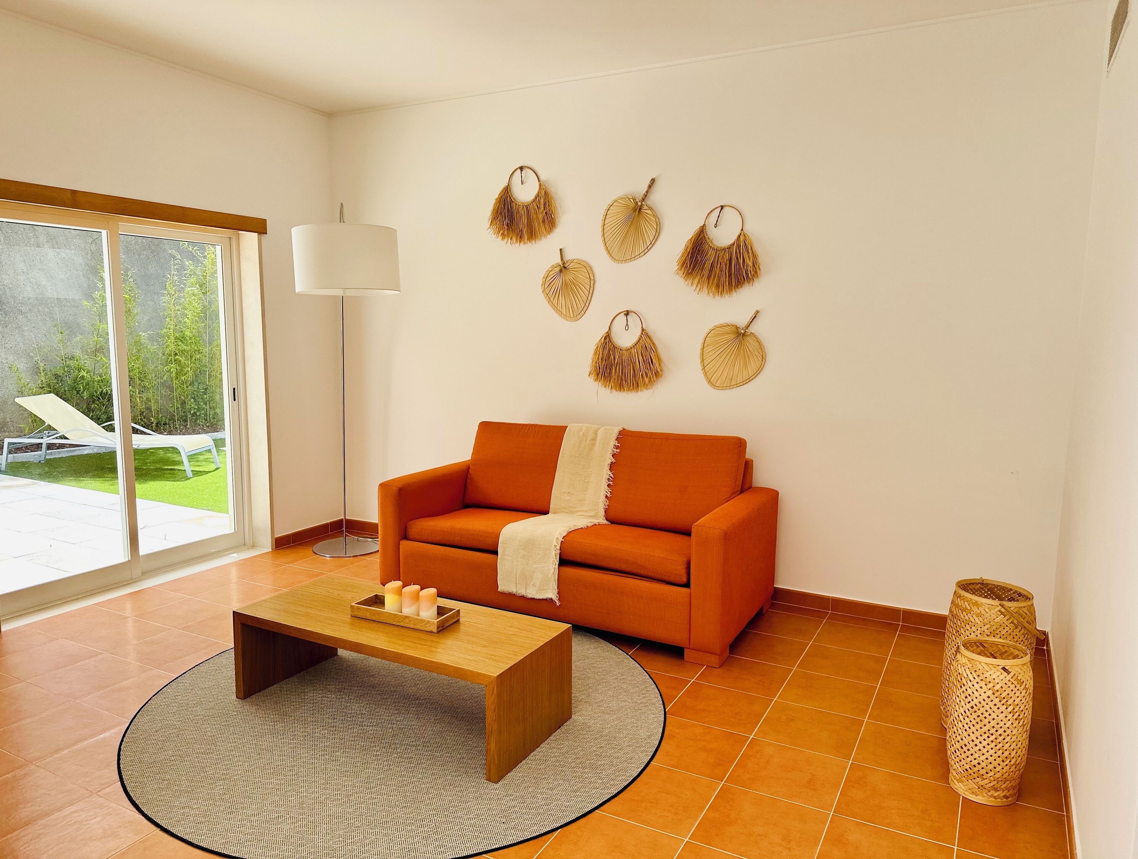 A modern living room with a sofa, a coffee table, and decorative wall hangings.