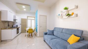 Luxury Apartment, City View | Living area | 55-inch LED TV with digital channels