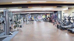 A gym with various exercise machines, treadmills, and weights. - Western Hotel (Chandrapur)