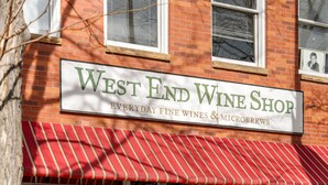 A storefront with a sign reading "West End Wine Shop" and a red and white striped awning. - New Listing! Executive Rental - Steps to Vibrant Pearl Street Mall (Boulder)