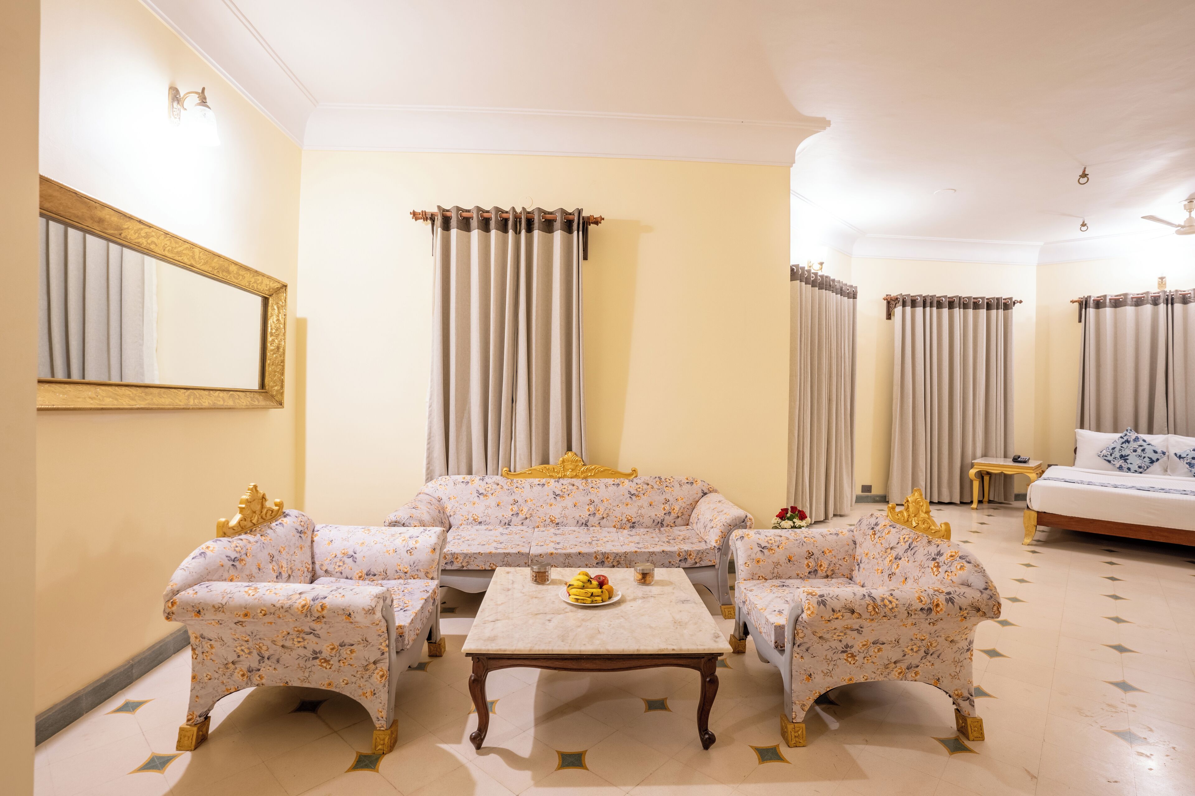A room with a sofa set, a coffee table, and curtains.